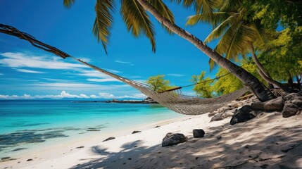 Fototapeta premium Hammock in the Caribbean tropics tropical island with coconut tree and pristine water turquoise blue and white sand by the beach with sea ocean