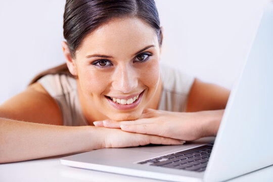 Happy, laptop and business woman in office with positive, good and confident attitude for career. Smile, pride and professional young female creative designer from Canada with computer in workplace.