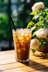 Iced coffee on a summer patio background with empty space for text 