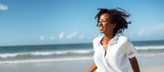 Fototapeta na wymiar Black woman walking on beach smiling happy