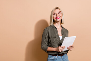 Photo of dreamy pretty woman dressed khaki shirt chatting instagram twitter telegram facebook empty...