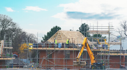 Roofers at work, installation of a new covering of a tiled roof. Working of scaffold platform