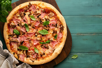 Pizza. Traditional Bacon pizza with ham, mushrooms, pickled cucumber and cheese and cooking...