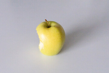Apple Aftermath: Bitten Fruit on White Background