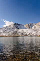 Snow covered mountain, water, and tundra at Summit Lake at Mount Evans/Mount Blue Sky near Idaho Springs, Colorado, on a sunny fall/winter day