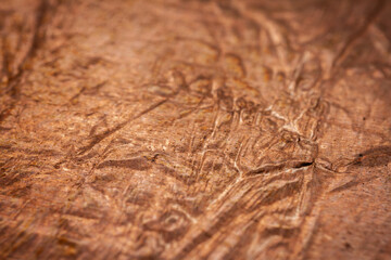 Extreme closeup of crumpled brass foil texture