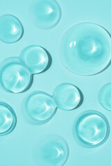 cosmetic smears cream texture on blue background. Beauty serum drop. Transparent and creamy skin care product sample.