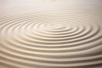 Sandy texture with circle lines on natural sand background, representing balance, harmony, and spirituality in Japanese zen garden.