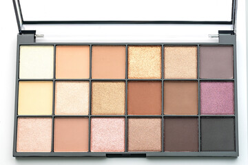 Set of nude eyeshadows in black case on white background. Top view. Closeup of eyeshadow palette....