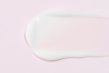 White cosmetic cream texture. lotion swatch on pink background. Beauty skin care product smear smudge drop. BB CC cream swipe sample