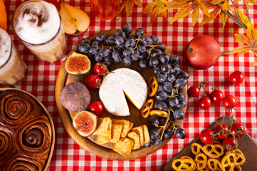 Autumn outdoor picnic set or dinner for celebration Thanksgiving Day. Holiday party. Festive table. Snacks, fruits, pie, vegetables, wine glasses.