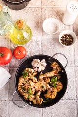 Cauliflower steak with spices and herbs cooked in the oven. Healthy vegan organic cuisine.
