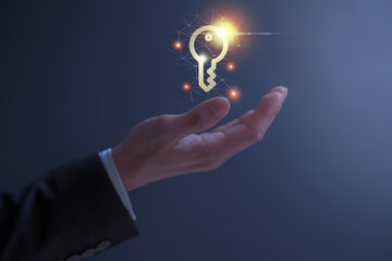 person holding virtual holographic key icon with light blurred background. Data protection privacy...
