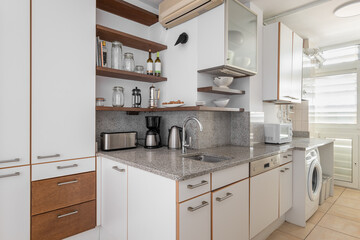 Fototapeta premium Kitchen with cabinets, sink and washing machine in flat