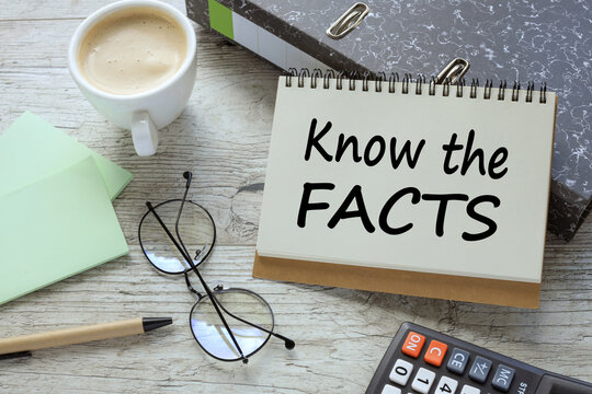 KNOW THE FACTS a cup of coffee. glasses. two office folder gray notepad. text on the page