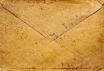 front view closeup of blank old aged closed letter paper envelope with torn edges from 1900