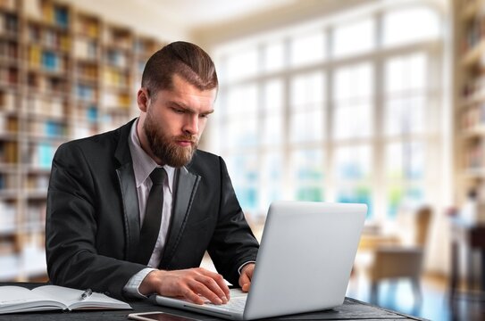 Thinking businessman sitting at desk in office, AI generated image