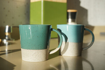 Obraz na płótnie Canvas Coffee mugs on the table in the morning light