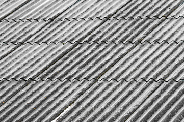 Background of snowy slate roof with wave texture