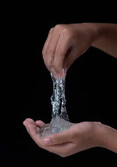 Hand stretches blue gel isolated on black background.