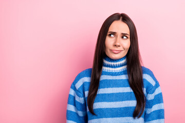 Portrait of nice minded young lady look interested empty space hesitate contemplate isolated on pink color background