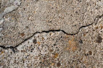 An old wall with a cracked texture is decorated with cement mortar
