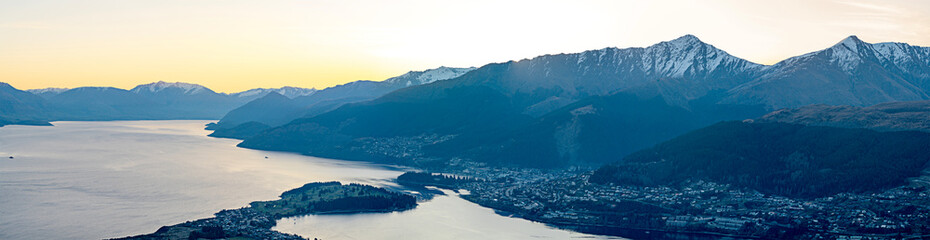 Gaze over the Southern Alps and an aerial view of Queenstown, New Zealand from the top of the Remarkables ski resort.