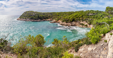 Panoramic view of Bay Cala Mitjana at south coast of Menorca (Balearic Islands) - obrazy, fototapety, plakaty