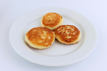Delicious, sweet, ruddy cheesecakes on a white plate.