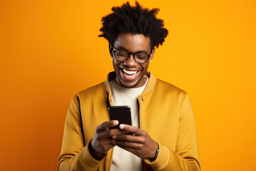 The excitement and joy of an African young man who is celebrating with his phone in his hand. - obrazy, fototapety, plakaty