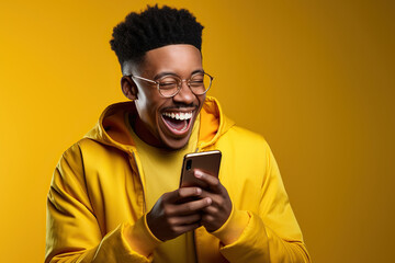 The excitement and joy of an African young man who is celebrating with his phone in his hand.