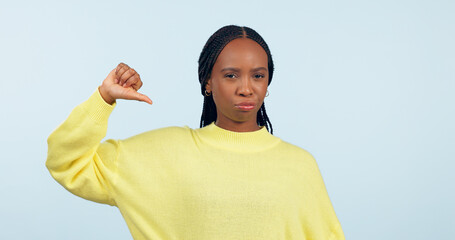 Thumbs down, portrait and hands of woman in studio for rejection of bad news, complaint and no...