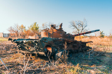 Destroyed burnt battle tank in the countryside. War in Ukraine