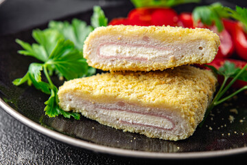 cordon bleu fresh cutlet chicken meat, cheese, bacon appetizer meal food snack on the table