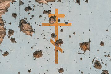 The wall of a Christian church damaged by shelling (close-up)