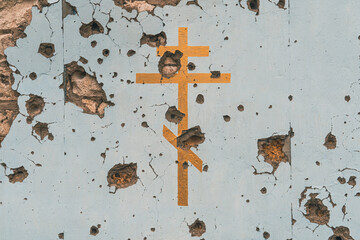 The wall of a Christian church damaged by shelling (close-up)