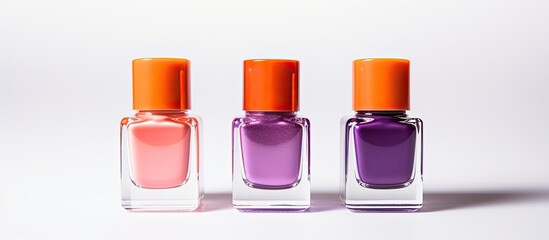 The white backdrop showcases nail polishes in shades of pink orange and purple