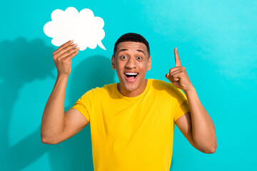 Portrait of surprised man wear trendy bright yellow t-shirt point finger up eureka bubble cloud...
