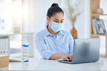 Laptop, covid and corporate employee with a face mask working on a project at a desk. Professional...