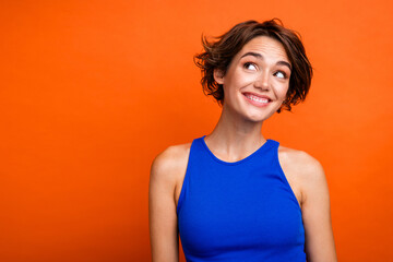 Photo portrait of nice young smiling cheerful girlfriend wear blue top looks empty space for good...