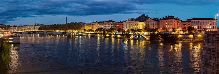 Fototapeta na wymiar Night panorama or the quary of the Celestins and Justice Palace bridge over the Saone river, Lyon, France