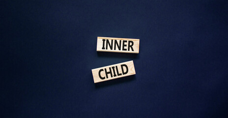 Inner child symbol. Concept words Inner child on beautiful wooden block. Beautiful black table black background. Psychological, motivational inner child concept. Copy space.