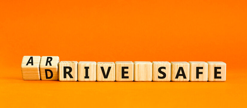 Drive and arrive safe symbol. Concept words Drive safe Arrive safe on wooden blocks. Beautiful orange table orange background. Business drive and arrive safe concept. Copy space.