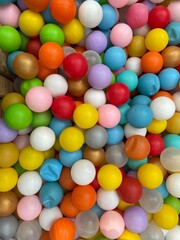 A pile of colorful plastic balls as a design background