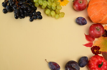 Assortment of fruits, grapes and nuts. Autumn seasonal harvest. pumpkin apples, red, yellow leaves. food still life with season fruits. Thanksgiving day, Halloween decoration fall design
