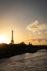 sunset over the river with a silhouette of the Eiffel tower