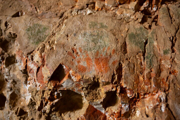 Petroglyphs on the rocks. An ancient caveman site. Historical rock paintings. There are human...