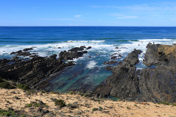 Fototapeta na wymiar Beautiful cliffs and coves with black basalt rocks in the coast of Alentejo, Portugal
