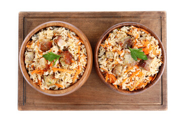 Delicious pilaf with meat and carrot in bowls isolated on white, top view