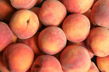 Many fresh peaches as background, top view